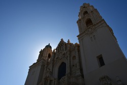 Top part of the facade of the Mission Dolores Basilica in San Francisco, seen from below, against a blue sky