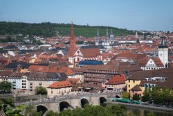 View of the old town of Würzburg in Bavaria, Germany, on a summer day, with the Old Main Bridge across the Main River in the foreground and the Marienkapelle church in the center
