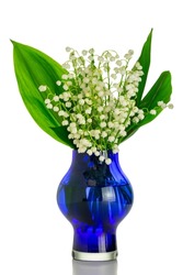 Bouquet of lilies of the valley in a blue vase on an isolated white background. Isolated floral still life with white flowers in a glass vase.