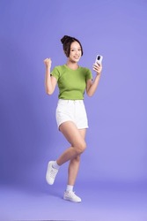 full body image of beautiful asian girl posing on pink background