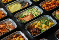 Business lunch in eco plastic container ready for delivery.Top view. Office Lunch boxes with food ready to go. Food takes away. Catering, brakfast. 