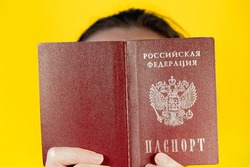 Girl with a Russian passport (translation - Russian Federation, Passport), the concept of travel and tourism in Russia and abroad.