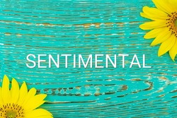 SENTIMENTAL - text, yellow flowers, sunflowers, wooden background (copy space).