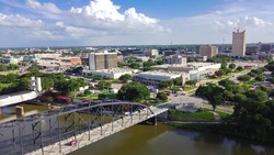 Aerial view downtown Waco from Washington Avenue Bridge cross Brazos River. A city in central Texas with vibrant Cultural District offers unique locally owned shops, restaurants, hotels