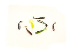 Colorful wide selection of Plastic Worms Baits Paddle Tail Swim baits with Chartreuse Glitter and ribbed design isolated on white background. Shad fishing lure swim bait clipping path and copy space