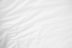 Abstract White Bedding Sheets or White wrinkled fabric background texture and Texture with copy-space :Creased or wrinkled white fabric,Soft focus