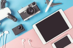 Travel Photographer gadgets and accessories object flat lay Top view on blue and pink background for travel concept with Blank Tablet and Mobile phone screen for Application mock up 