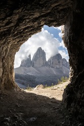 light at the end of the tunnel. View through a hole at the Tre Cime. Three Peaks. Dolomites, Unesco world heritage