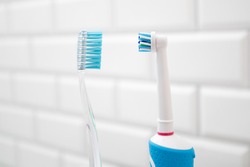 An electric toothbrush versus a regular toothbrush.
