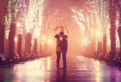 Couple with umbrella kissing at night alley.