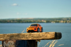 Toy car on the background of the Dnieper river