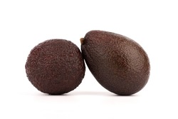 Close-up of two ripe avocados on a white background.