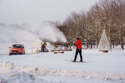 the skier waits for the snow cannons to make the snow for the ski track