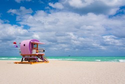 Sunny coastal beach with colorful life guard tower at South Beach, Miami-Dade, Florida USA