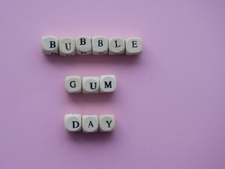 Bubble gum day. Pink background with text Bubble Gum Day with place for your text. Copy space.