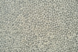 Gray textured stone sea pebbles wall, texture, pattern, background.