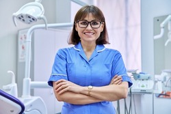 Portrait of smiling nurse looking at camera in dentistry.