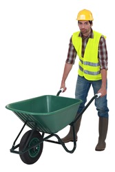 Unfriendly labourer pushing a wheelbarrow