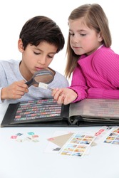 Two kids collecting stamps.