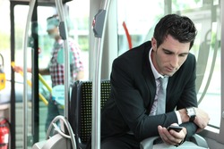 man texting in a bus