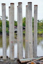 Cement pillars stuck on the banks of rivers in swamp areas for the construction of bridges in rural areas. cement pillar construction is more appropriate to avoid construction rust