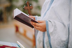 Priest Holding A Bible