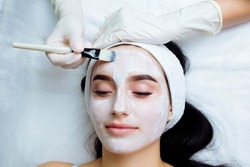 Facial rejuvenation procedure with cream. Spa and cosmetology skin care. Beauty mask Close-up