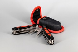 Multipurpose Tool - Multipurpose pliers, knife, screwdriver, hook, saw on a neutral background - Isolated