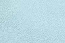 Surface of genuine leather close-up, pastel blue color. Background, pattern, texture