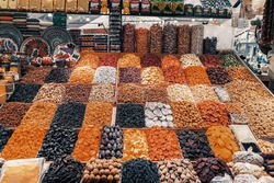 Rich assortment of nuts and dried fruits on counter at wholesale market. Healthy nutrition, Vegan sweets. Natural vitamins. Food background