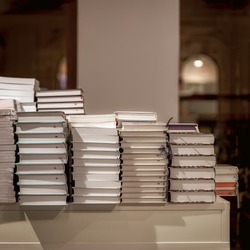 Stacks, stops of books on table, modern urban bookshop, library. Education, school, study concept. For background copy space