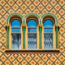 Arched colorful windows on vivid wall with multi colored tiles