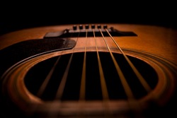 Guitar.Guitar's chords.Acoustic guitar.Music.Music background.Image of an acoustic guitar in the dark.Playing music with some friends in the dark.Classical music.Guitar closeup