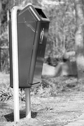 close up of a trash can in the park in black and white monochrome streetart