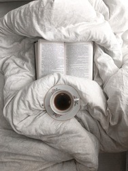morning cup of tea on the bed, book