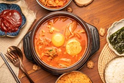Kimchi stew or Kimchi soup, Korea’s national dish spicy soup with vegetable, meat, eggs, tofu served in a hot pot. Kimchi Jjigae korean trditional food.