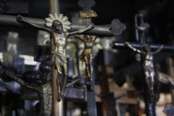 Crucifix of Jesus on the cross, on blurred background of group crucifixes. Symbol of religion and Christian faith. 