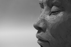 Profile face sculpture. Black and white style. Female clay portrait with closed eyes.