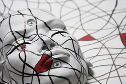Female face portrait. Sculpture of white face with closed eyes. Abstract geometric pattern, inspired by the painter Mondrian