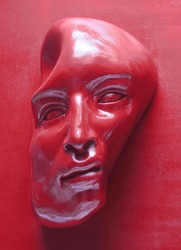 Red face, distorted on red background. Sculpture, fine arts, figurative and contemporary art.