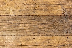 Close up photo of old vertical timber wall. Open air hardwood stage floor. Rough timber background. Old vertical wooden wall. Brown weathered hardwood parquet floor. Aged timber texture background 