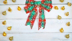  red Christmas bow on a white wooden background banner. Christmas background, photo for a postcard or gift bag