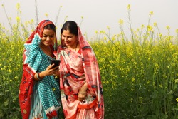 Indian rural ladies using phone in village