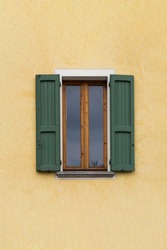 Traditional window of Italian house with closing doors in wood. High quality photo