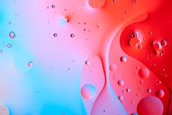 Mixing water and oil, beautiful color abstract background based on red and yellow circles and ovals, macro abstraction