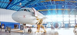 Panoramic view of aerospace hangar, civil aviation aircraft, repair and maintenance of mechanical parts in an industrial workshop