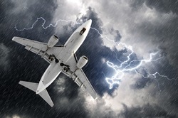 Airplane approach at the airport landing in bad weather storm hurricane rain llightning strike.