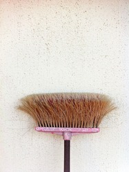 Broom leaning against the wall.