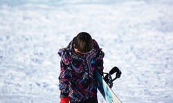 boy with snowboard in the snow in snow clothes ready for winter sport