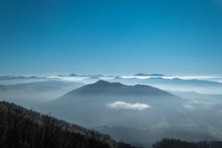 Panoramic view from the mountain of La Rhune in the Basque Country with mountains in the background with some fog in the highs